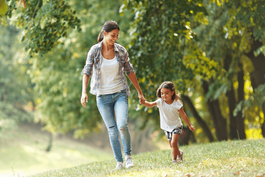 mother and daughter walking in the park